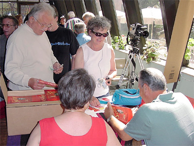 Sotir Nitchov and his wife Tina signing copies of his book for Pete Kondoff and Olga Sondolowich